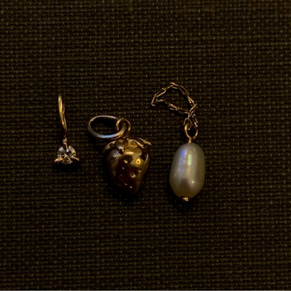 Gold charm bracelet with three charms
